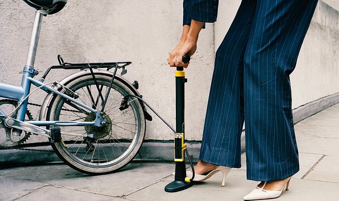 pumping up bike tyres with hand pump